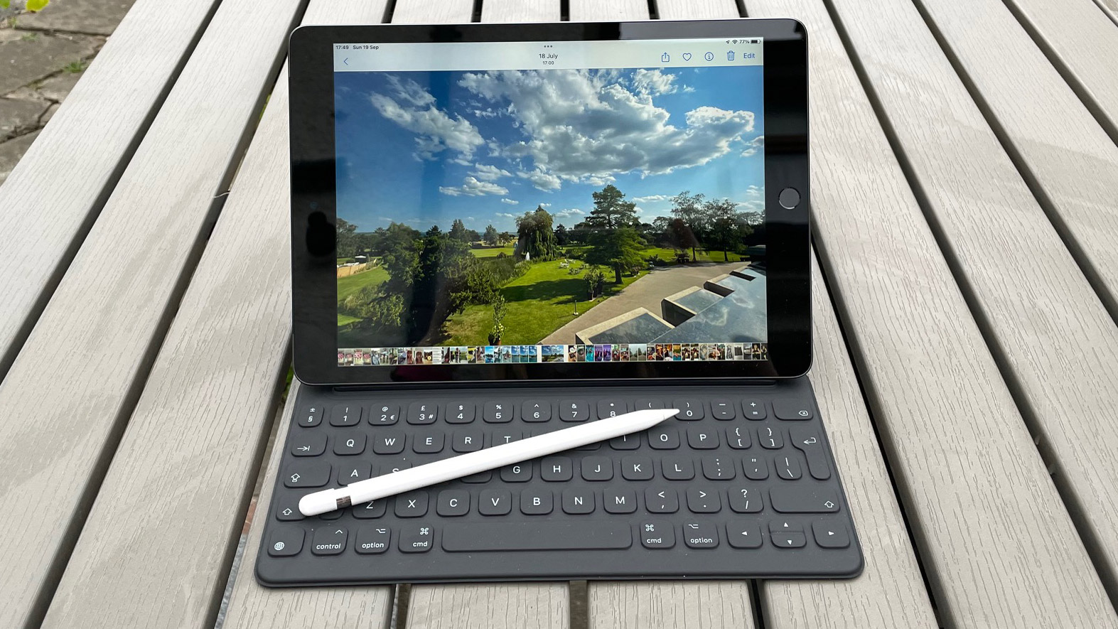 Best iPad Apple iPad 10.2 (2021) with the smart keyboard attached, with an Apple Pencil resting on the keyboard, outside